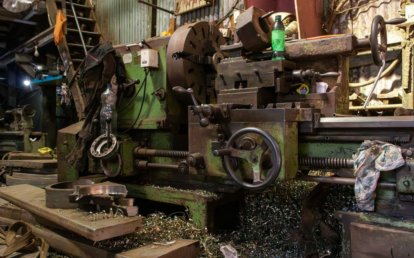 Industrial lathe with metal shavings in a workshop
